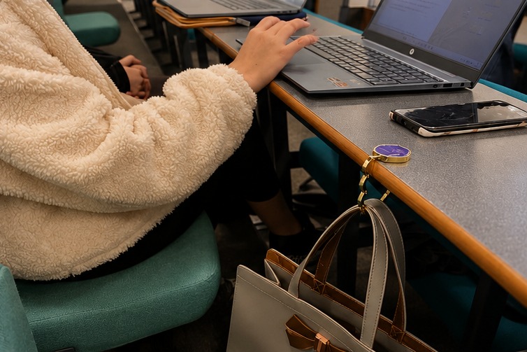 HERUNO HALO in use on a desk in an office atrium, next to a laptop