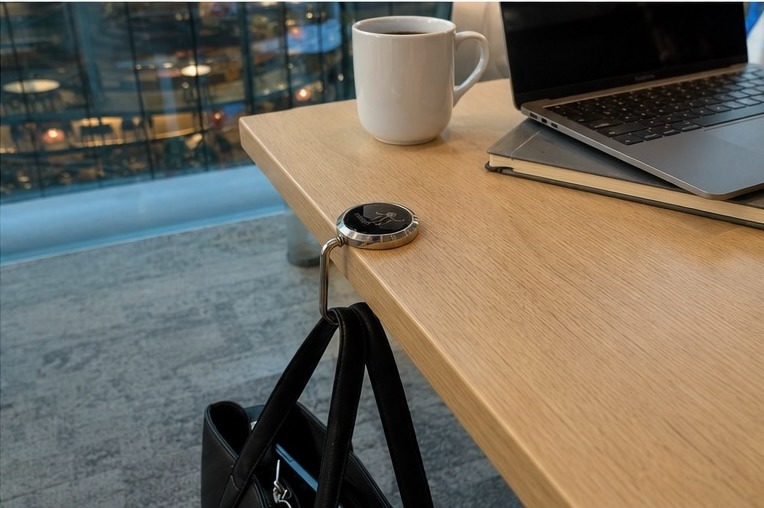 HERUNO HALO in use on a desk in an office atrium, next to a laptop